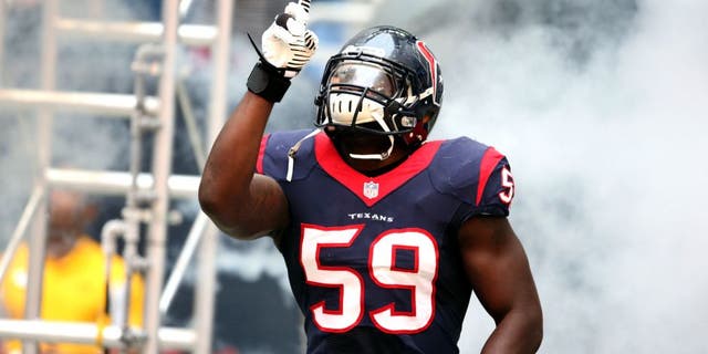 Dec 1, 2013; Houston, TX, USA; Houston Texans linebacker Whitney Mercilus (59) points as he is introduced prior to the game against the New England Patriots at Reliant Stadium. Mandatory Credit: Matthew Emmons-USA TODAY Sports
