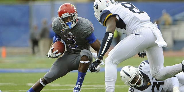 Nov 16, 2013; Lawrence, KS, USA; Kansas Jayhawks running back Tony Pierson (3) runs for yardage against West Virginia Mountaineers linebacker Isaiah Bruce (31) and safety Karl Joseph (8) in the first half at Memorial Stadium. Mandatory Credit: John Rieger-USA TODAY Sports