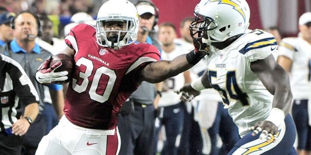 Aug 22, 2015; Glendale, AZ, USA; Arizona Cardinals running back Stepfan Taylor (30) stiff arms San Diego Chargers outside linebacker Melvin Ingram (54) during the first half at University of Phoenix Stadium. The Chargers won 22-19. Mandatory Credit: Joe Camporeale-USA TODAY Sports