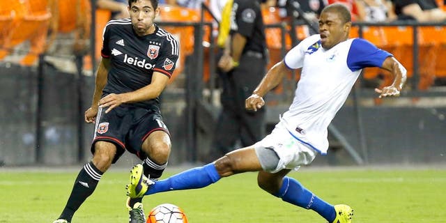 Aug 25, 2015; Washington, DC, USA; D.C. United midfielder Miguel Aguilar (17) passes the ball as Montego Bay F.C. defender Dwayne Holmes (5) defends in the first half at RFK Stadium. United won 3-0. Mandatory Credit: Geoff Burke-USA TODAY Sports
