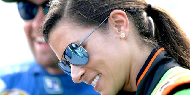 DAYTONA BEACH, FL - JULY 04: Danica Patrick, driver of the #10 GoDaddy Chevrolet, speaks with Ricky Stenhouse Jr., driver of the #17 Fifth Third Bank Ford, during qualifying for the NASCAR Sprint Cup Series Coke Zero 400 at Daytona International Speedway on July 4, 2015 in Daytona Beach, Florida. (Photo by Patrick Smith/Getty Images)