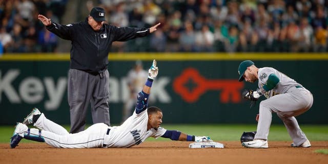 SEATTLE, WA - AUGUST 25: Robinson Cano #22 of the Seattle Mariners gestures after doubling against second baseman Brett Lawrie #15 of the Oakland Athletics in the seventh inning at Safeco Field on August 25, 2015 in Seattle, Washington. The double gave Cano 30 for 11 consecutive seasons. (Photo by Otto Greule Jr/Getty Images)