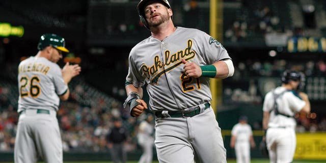 SEATTLE, WA - AUGUST 24: Stephen Vogt #21 of the Oakland Athletics heads to the dugout after scoring in the ninth inning against the Seattle Mariners at Safeco Field on August 24, 2015 in Seattle, Washington. (Photo by Otto Greule Jr/Getty Images)