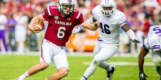Oct 18, 2014; Columbia, SC, USA; South Carolina Gamecocks quarterback Connor Mitch (6) scrambles for yardage as Furman Paladins linebacker Cory Magwood (46) pursues in the second half at Williams-Brice Stadium. Mandatory Credit: Jeff Blake-USA TODAY Sports