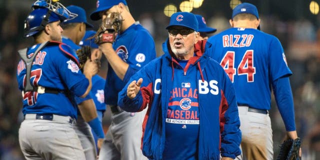 August 25, 2015; San Francisco, CA, USA; Chicago Cubs manager Joe Maddon (70) completes a pitching change during the seventh inning against the San Francisco Giants at AT&T Park. Mandatory Credit: Kyle Terada-USA TODAY Sports