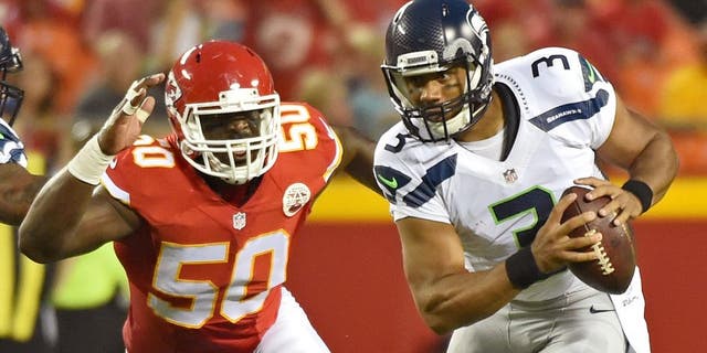 KANSAS CITY, MO - AUGUST 21: Quarterback Russell Wilson #3 of the Seattle Seahawks scrambles away from linebacker Justin Houston #50 of the Kansas City Chiefs during the first half of a preseason game at Arrowhead Stadium on August 21, 2015 in Kansas City, Missouri. (Photo by Peter G. Aiken/Getty Images)