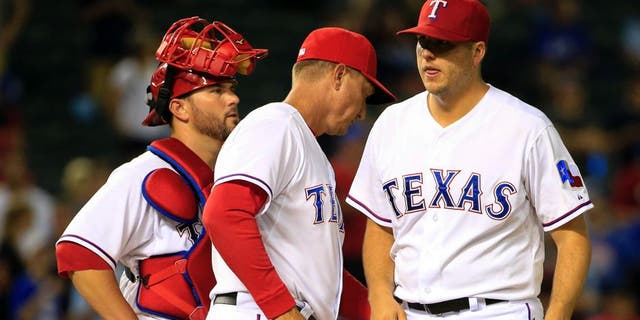Aug 25, 2015; Arlington, TX, USA; Texas Rangers manager Jeff Banister (middle) takes out relief pitcher Shawn Tolleson (37) during the ninth inning against the Toronto Blue Jays at Globe Life Park in Arlington. Mandatory Credit: Kevin Jairaj-USA TODAY Sports