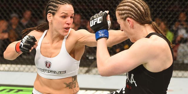 MONTREAL, QC - APRIL 25: (L-R) Alexis Davis of Canada punches Sarah Kaufman of Canada in their women's bantamweight bout during the UFC 186 event at the Bell Centre on April 25, 2015 in Montreal, Quebec, Canada. (Photo by Josh Hedges/Zuffa LLC/Zuffa LLC via Getty Images)