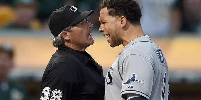 OAKLAND, CA - AUGUST 22: James Loney #21 of the Tampa Bay Rays argues with home plate umpire Paul Nauert #39 after Nauert threw Loney out of the game against the Oakland Athletics in the top of the six inning at O.co Coliseum on August 22, 2015 in Oakland, California. (Photo by Thearon W. Henderson/Getty Images)