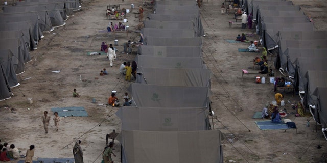 Aug. 26: Pakistanis displaced by flooding sit outside tents at a temporary camp operated by the Army in southern Pakistan.