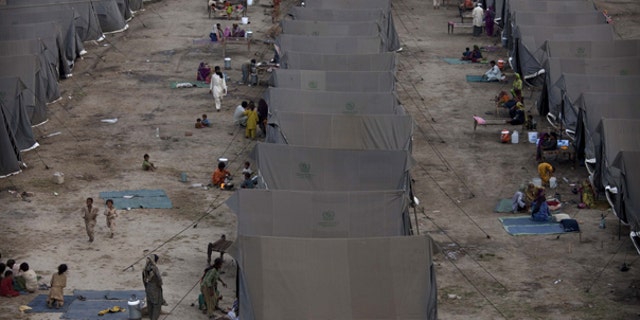 Aug. 26: Pakistanis displaced by flooding sit outside tents at a temporary camp operated by the Army in southern Pakistan.