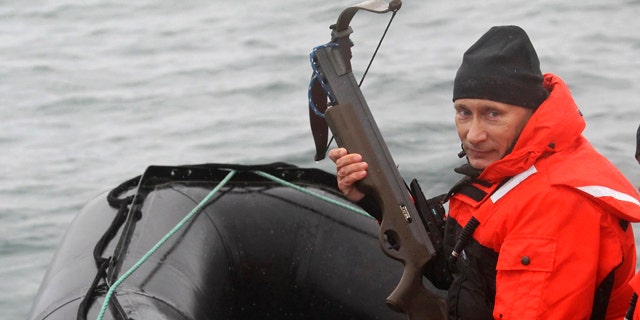 Aug. 25: Russian Prime Minister Vladimir Putin holds a crossbow as he sits on a rubber boat at the Olga Harbor of Kamchatka Peninsula during a scientific expedition.