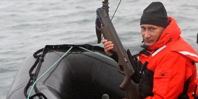 Aug. 25: Russian Prime Minister Vladimir Putin holds a crossbow as he sits on a rubber boat at the Olga Harbor of Kamchatka Peninsula during a scientific expedition.