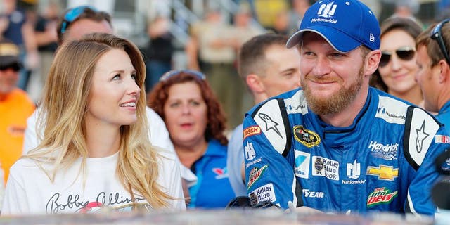BRISTOL, TN - AUGUST 22: Dale Earnhardt Jr., driver of the #88 Nationwide Chevrolet, stands on the grid with his fiance, Amy Reimann, prior to the NASCAR Sprint Cup Series IRWIN Tools Night Race at Bristol Motor Speedway on August 22, 2015 in Bristol, Tennessee. (Photo by Brian Lawdermilk/Getty Images)