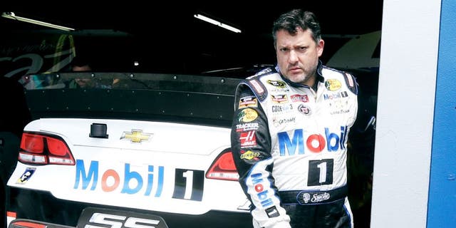 Tony Stewart leaves the garage after a practice session Friday, Aug. 14, 2015, for Sunday's NASCAR Sprint Cup series auto race at Michigan International Speedway in Brooklyn, Mich. (AP Photo/Carlos Osorio)
