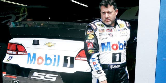 Tony Stewart leaves the garage after a practice session Friday, Aug. 14, 2015, for Sunday's NASCAR Sprint Cup series auto race at Michigan International Speedway in Brooklyn, Mich. (AP Photo/Carlos Osorio)