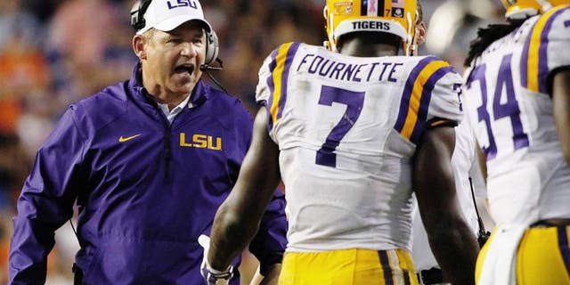 Oct 11, 2014; Gainesville, FL, USA; LSU Tigers head coach Les Miles congratulates running back Leonard Fournette (7) after he scored a touchdown against the Florida Gators during the second half at Ben Hill Griffin Stadium. LSU Tigers defeated the Florida Gators 30-27. Mandatory Credit: Kim Klement-USA TODAY Sports