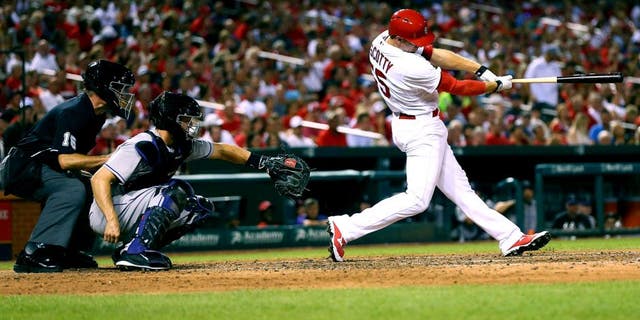 ST. LOUIS, MO - JULY 31: Stephen Piscotty #55 of the St. Louis Cardinals hits a two-RBI double against the Colorado Rockies in the sixth inning at Busch Stadium on July 31, 2015 in St. Louis, Missouri. (Photo by Dilip Vishwanat/Getty Images)