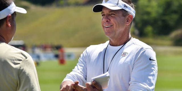 Aug 3, 2015; White Sulphur Springs, WV, USA; New Orleans Saints head coach Sean Payton speaks with a member of his staff following a day of training camp at The Greenbrier. Mandatory Credit: Michael Shroyer-USA TODAY Sports