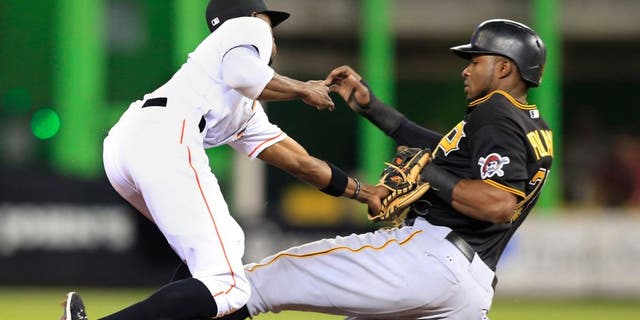 Aug 27, 2015; Miami, FL, USA; Pittsburgh Pirates right fielder Gregory Polanco (25) is out stealing as Miami Marlins second baseman Dee Gordon (9) makes the tag in the first inning at Marlins Park. Mandatory Credit: Robert Mayer-USA TODAY Sports