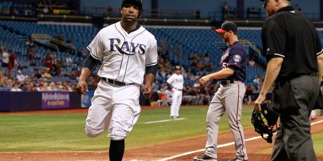 Aug 27, 2015; St. Petersburg, FL, USA; Tampa Bay Rays designated hitter Joey Butler (9) scores a run on a wild pitch by Minnesota Twins relief pitcher Neal Cotts (55) during the sixth inning at Tropicana Field. Mandatory Credit: Kim Klement-USA TODAY Sports