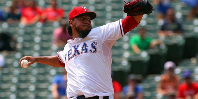 Aug 27, 2015; Arlington, TX, USA; Texas Rangers starting pitcher Yovani Gallardo (49) pitches in the first inning against the Toronto Blue Jays at Globe Life Park in Arlington. Mandatory Credit: Ray Carlin-USA TODAY Sports