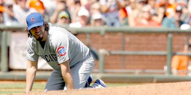 Aug 27, 2015; San Francisco, CA, USA; Chicago Cubs pitcher Dan Haren (50) kneels on the ground after fielding an infield single against the San Francisco Giants in the fourth inning at AT&T Park. The Giants defeated the Cubs 9-1. Mandatory Credit: Cary Edmondson-USA TODAY Sports