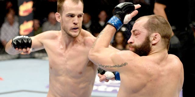 DULUTH, GA - JANUARY 15: (L-R) Cole Miller punches Sam Sicilia in their featherweight fight during the UFC Fight Night event inside The Arena at Gwinnett Center on January 15, 2014 in Duluth, Georgia. (Photo by Jeff Bottari/Zuffa LLC/Zuffa LLC via Getty Images) *** Local Caption *** Sam Sicilia; Cole Miller