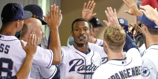 SAN DIEGO, CA - AUGUST 18: Melvin Upton Jr. #2 of the San Diego Padres, center, is congratulated after hitting a two-run home run during the sixth inning of a baseball game against the Atlanta Braves at Petco Park August 18, 2015 in San Diego, California. (Photo by Denis Poroy/Getty Images)