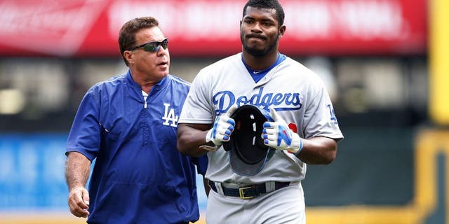 CINCINNATI, OH - AUGUST 27: Yasiel Puig #66 of the Los Angeles Dodgers leaves the field after suffering an injury beating out a throw to first base in the ninth inning against the Cincinnati Reds at Great American Ball Park on August 27, 2015 in Cincinnati, Ohio. The Dodgers defeated the Reds 1-0. (Photo by Joe Robbins/Getty Images)