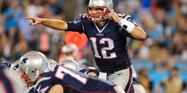 Aug 28, 2015; Charlotte, NC, USA; New England Patriots quarterback Tom Brady (12) calls out the signal change during the second quarter at Bank of America Stadium. Mandatory Credit: Jim Dedmon-USA TODAY Sports