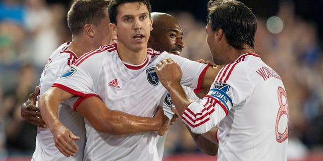 Aug 28, 2015; San Jose, CA, USA; San Jose Earthquakes midfielder Shea Salinas (6) celebrates with midfielder Marc Pelosi (33) and defender Marvell Wynne (4) and forward Chris Wondolowski (8) after scoring a goal against the Los Angeles Galaxy during the first half at Avaya Stadium. Mandatory Credit: Ed Szczepanski-USA TODAY Sports