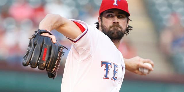 Aug 28, 2015; Arlington, TX, USA; Texas Rangers starting pitcher Cole Hamels (35) throws a pitch in the first inning at bat at Globe Life Park in Arlington. Mandatory Credit: Tim Heitman-USA TODAY Sports
