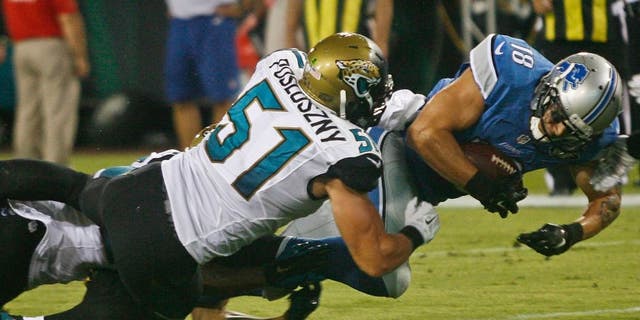 Aug 28, 2015; Jacksonville, FL, USA; Detroit Lions wide receiver Greg Salas (18) dives for extra yardage as Jacksonville Jaguars linebacker Paul Posluszny (51) tackles in the second quarter of a preseason NFL football game at EverBank Field. Mandatory Credit: Phil Sears-USA TODAY Sports