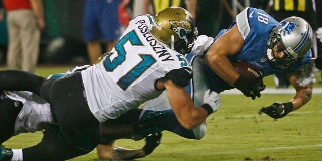 Aug 28, 2015; Jacksonville, FL, USA; Detroit Lions wide receiver Greg Salas (18) dives for extra yardage as Jacksonville Jaguars linebacker Paul Posluszny (51) tackles in the second quarter of a preseason NFL football game at EverBank Field. Mandatory Credit: Phil Sears-USA TODAY Sports