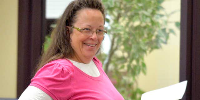 Aug. 18, 2015: Rowan County Clerk Kim Davis smilesas she helps a customer at the Rowan County Courthouse in Morehead, Ky.