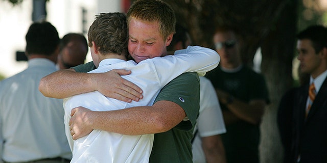 Aug. 29: Stephen Henriksen, right, gets a hug from fellow church member Ryan Henshaw after a shooting that killed lay bishop Clay Sannar of the Church of Jesus Christ of Latter-Day Saints in Visalia, Calif.