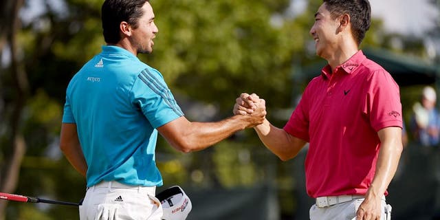 EDISON, NJ - AUGUST 29: Jason Day of Australia (L) and Sang-Moon Bae of Korea shake hands on the18th green during the third round of The Barclays at Plainfield Country Club on August 29, 2015 in Edison, New Jersey. (Photo by Ross Kinnaird/Getty Images)
