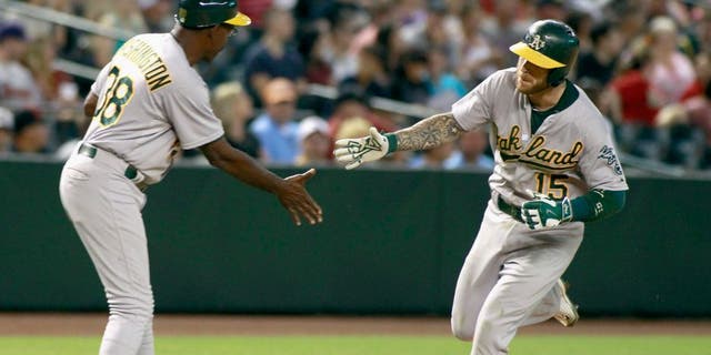 PHOENIX, AZ - AUGUST 28: Brett Lawrie #15 of the Oakland Athletics is congratulated by third base coach Ron Washington #38 after hitting a two-run home run against the Arizona Diamondbacks during the ninth inning of a MLB game at Chase Field on August 28, 2015 in Phoenix, Arizona. (Photo by Ralph Freso/Getty Images)