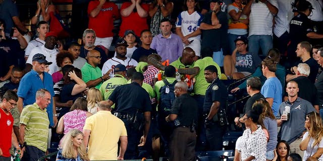 ATLANTA, GA - AUGUST 29: Emergency medical staff help a fan that fell from the upper deck of Turner Field during the game between the Atlanta Braves and the New York Yankees on August 29, 2015 in Atlanta, Georgia. (Photo by Mike Zarrilli/Getty Images)