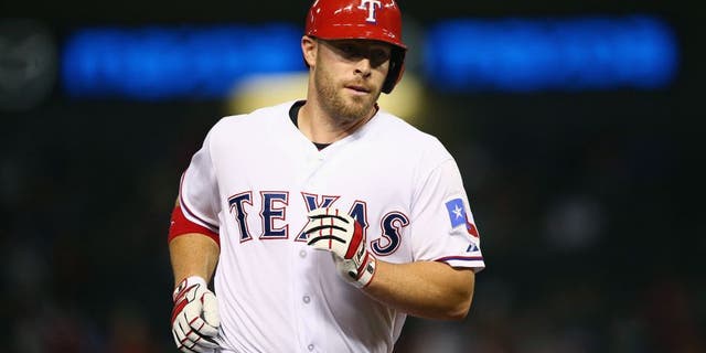 ARLINGTON, TX - AUGUST 28: Chris Gimenez #38 of the Texas Rangers hits a home run in the fifth inning against the Baltimore Orioles at Globe Life Park in Arlington on August 28, 2015 in Arlington, Texas. (Photo by Ronald Martinez/Getty Images)