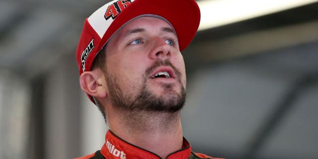SPARTA, KY - JULY 10: Michael Annett, driver of the #46 Pilot/Flying J Chevrolet, looks on from the garage area during a rain delay in practice for the NASCAR Sprint Cup Series Quaker State 400 Presented by Advance Auto Parts at Kentucky Speedway on July 10, 2015 in Sparta, Kentucky. (Photo by Todd Warshaw/Getty Images)