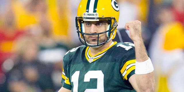 Sep 28, 2015; Green Bay, WI, USA; Green Bay Packers quarterback Aaron Rodgers (12) celebrates a touchdown pass during the first quarter against the Kansas City Chiefs at Lambeau Field. Mandatory Credit: Jeff Hanisch-USA TODAY Sports