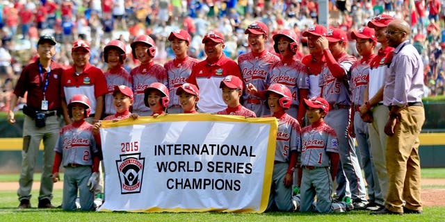 SOUTH WILLAMSPORT, PA - AUGUST 29: Members of team Japan pose with the banner after defeating team Mexico during the International Championship game of the Little League World Series at Lamade Stadium on August 29, 2015 in South Willamsport, Pennsylvania. (Photo by Rob Carr/Getty Images)