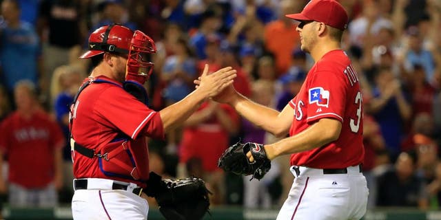 Aug 29, 2015; Arlington, TX, USA; Texas Rangers catcher Bobby Wilson (left) celebrates with relief pitcher Shawn Tolleson (37) after the victory against the Baltimore Orioles at Globe Life Park in Arlington. Mandatory Credit: Kevin Jairaj-USA TODAY Sports