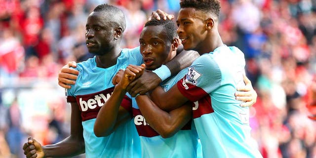 LIVERPOOL, ENGLAND - AUGUST 29: Diafra Sakho (C) of West Ham United celebrates scoring his team's third goal with his team mates Cheikhou Kouyate (L) and Reece Oxford (R) during the Barclays Premier League match between Liverpool and West Ham United at Anfield on August 29, 2015 in Liverpool, England. (Photo by Clive Mason/Getty Images)