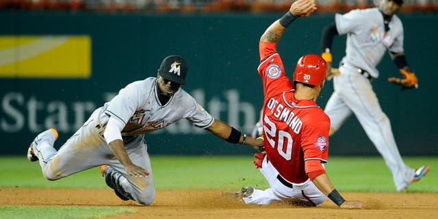 Aug 29, 2015; Washington, DC, USA; Miami Marlins second baseman Dee Gordon (9) tags out Washington Nationals shortstop Ian Desmond (20) attempting to steal second base during the fourth inning at Nationals Park. Mandatory Credit: Brad Mills-USA TODAY Sports