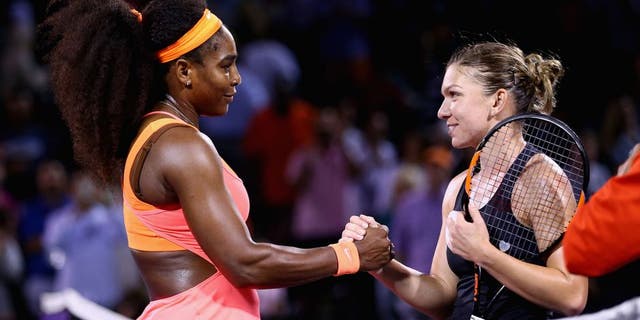 KEY BISCAYNE, FL - APRIL 02: Serena Williams of the United States shakes hands at the net after her three set victory against Simona Halep of Romania in their semi final match during the Miami Open Presented by Itau at Crandon Park Tennis Center on April 2, 2015 in Key Biscayne, Florida. (Photo by Clive Brunskill/Getty Images)