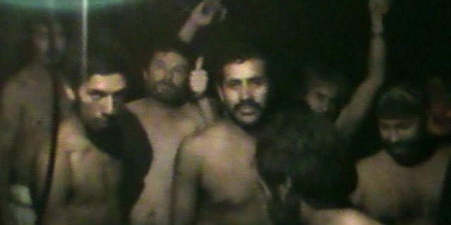 Aug. 29: This TV grab taken from a video released by Chile's government shows some of 33 trapped miners the San Jose mine in Copiapo.