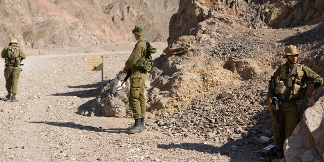 Aug. 19: Israeli soldiers secure the area near roads leading to the sites of several attacks in the Arava desert, near the southern Israeli resort town of Eilat.